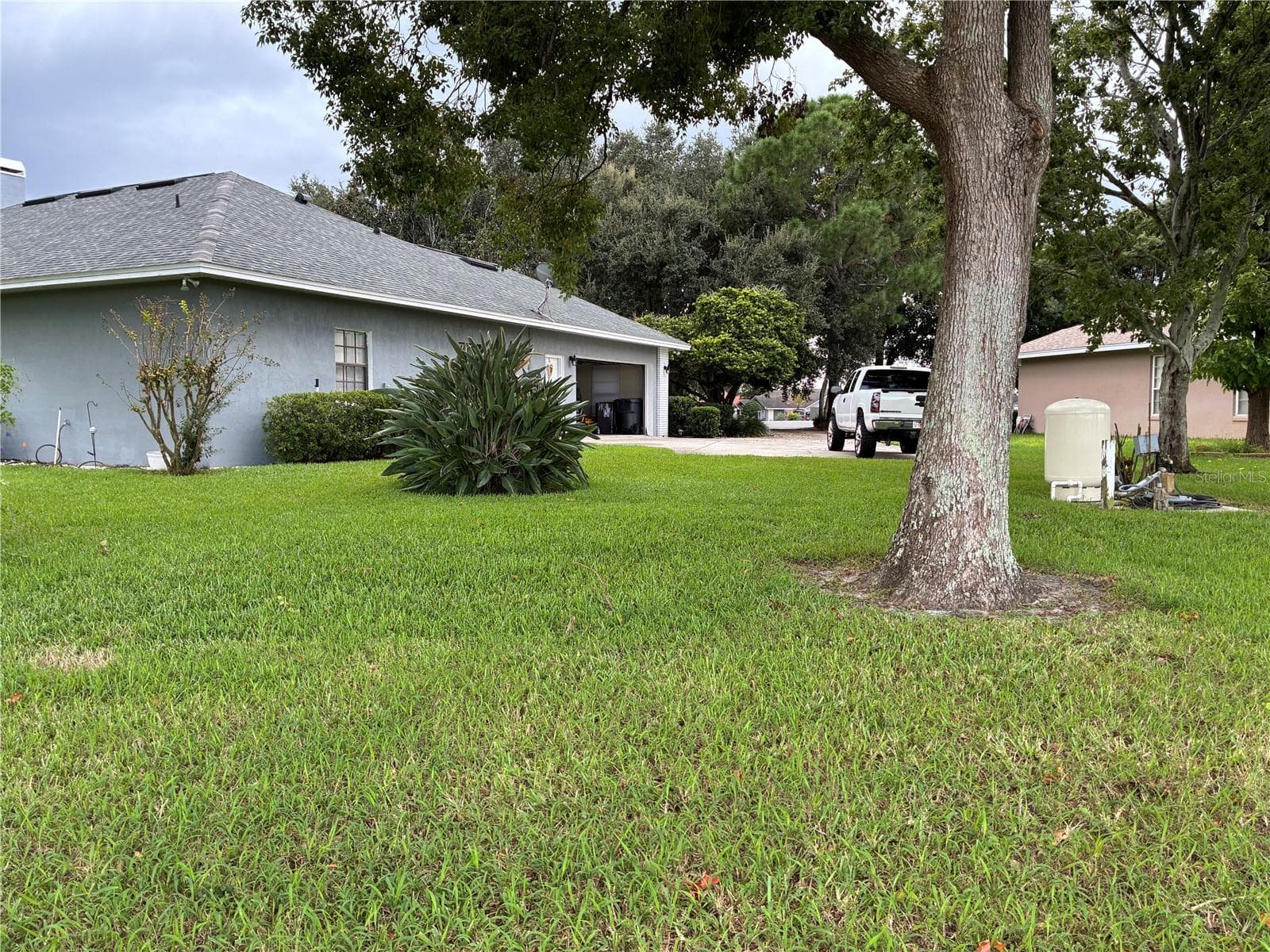 GARAGE SIDE VIEW OF YARD - 14 CRYSTAL WATERS DR, WINTER HAVEN