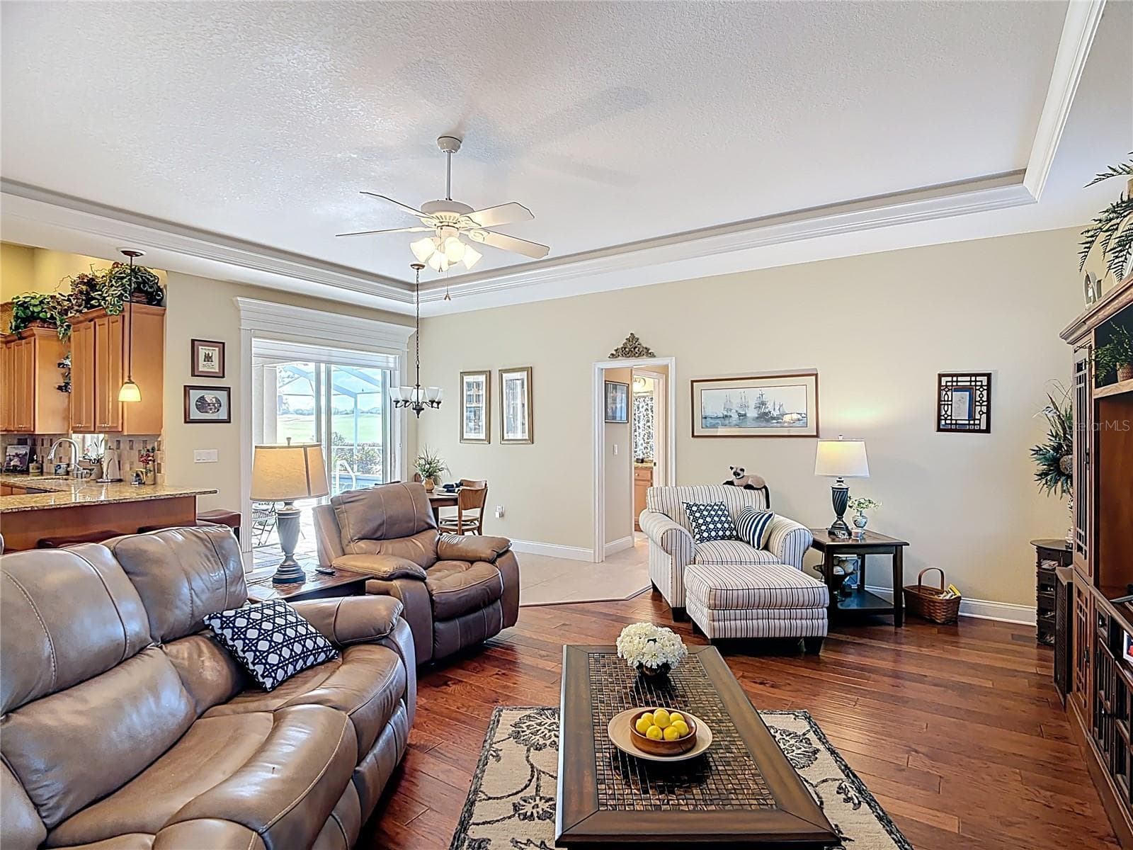 Sliders in family room open to pool at casual dining area - 455 OSPREY LANDING WAY, LAKELAND