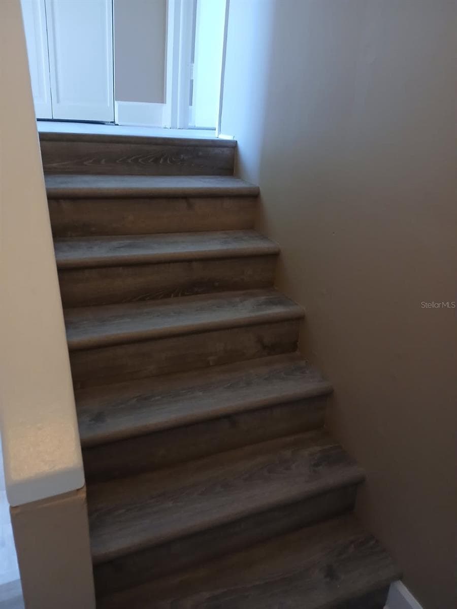 Stairs and upper-level carpet have been replaced with LVP - 8719 COVE CT #10, TAMPA