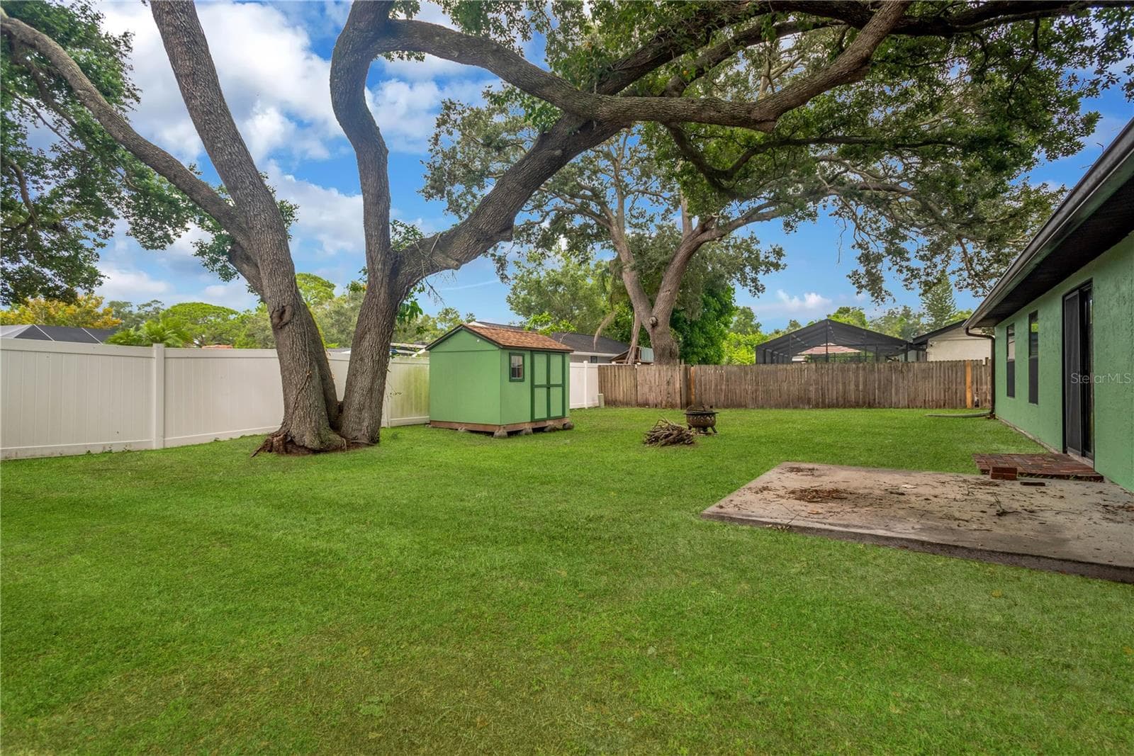 Brick paver Patio just outside sliding glass doors with concrete pad for patio furniture. - 5546 34TH CT E, BRADENTON
