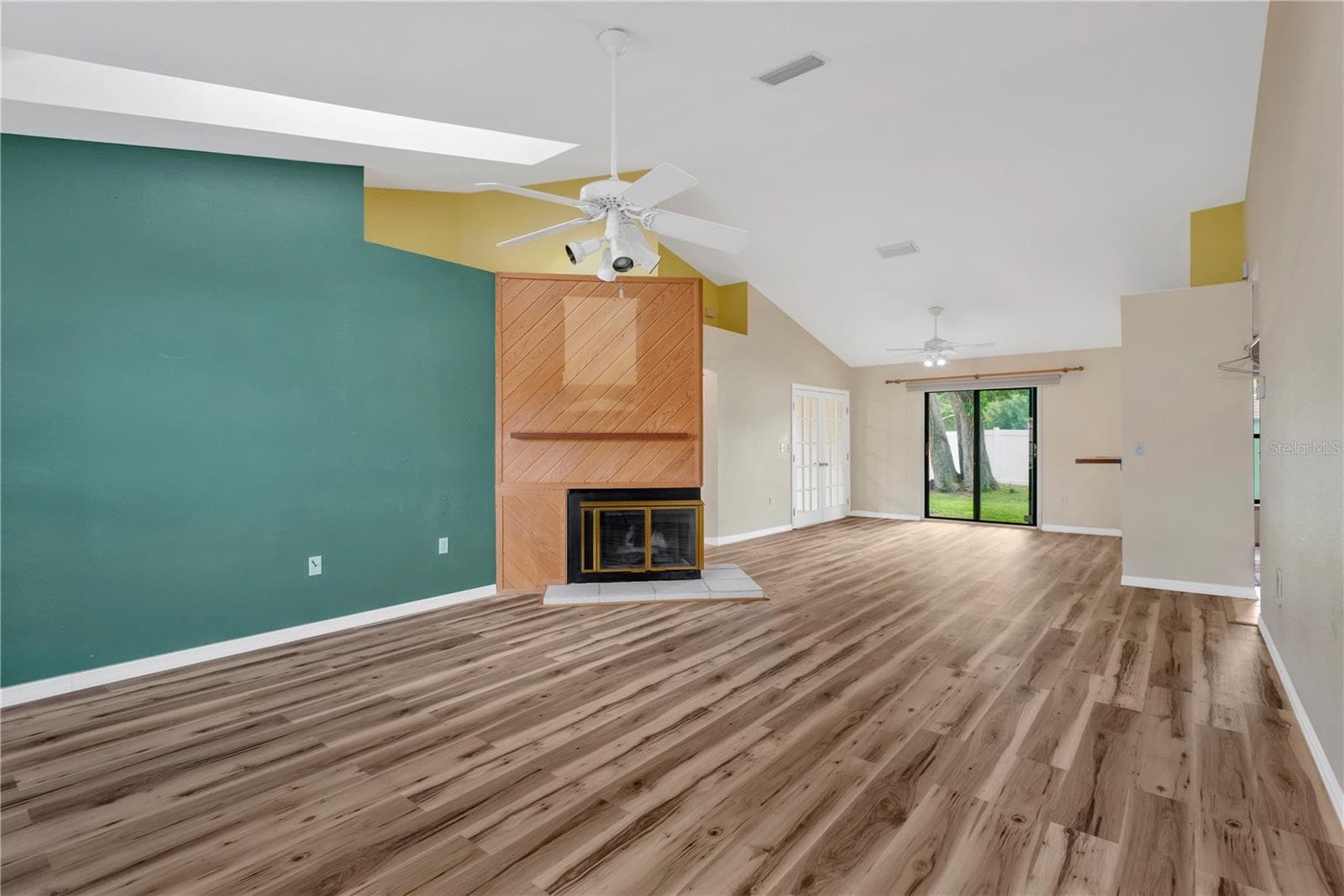 Living Room, Dining Room and French Doors leading into Office. Sliders leading out to patio in backyard. - 5546 34TH CT E, BRADENTON