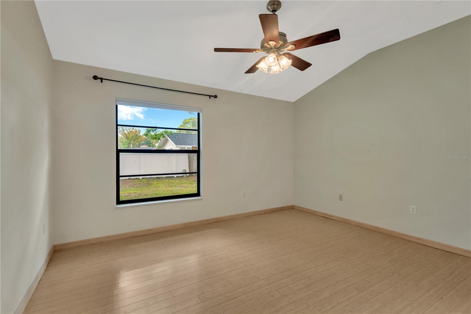 Primary Bedroom with lofted ceiling and ceiling fan, overlooking the private backyard - 5546 34TH CT E, BRADENTON