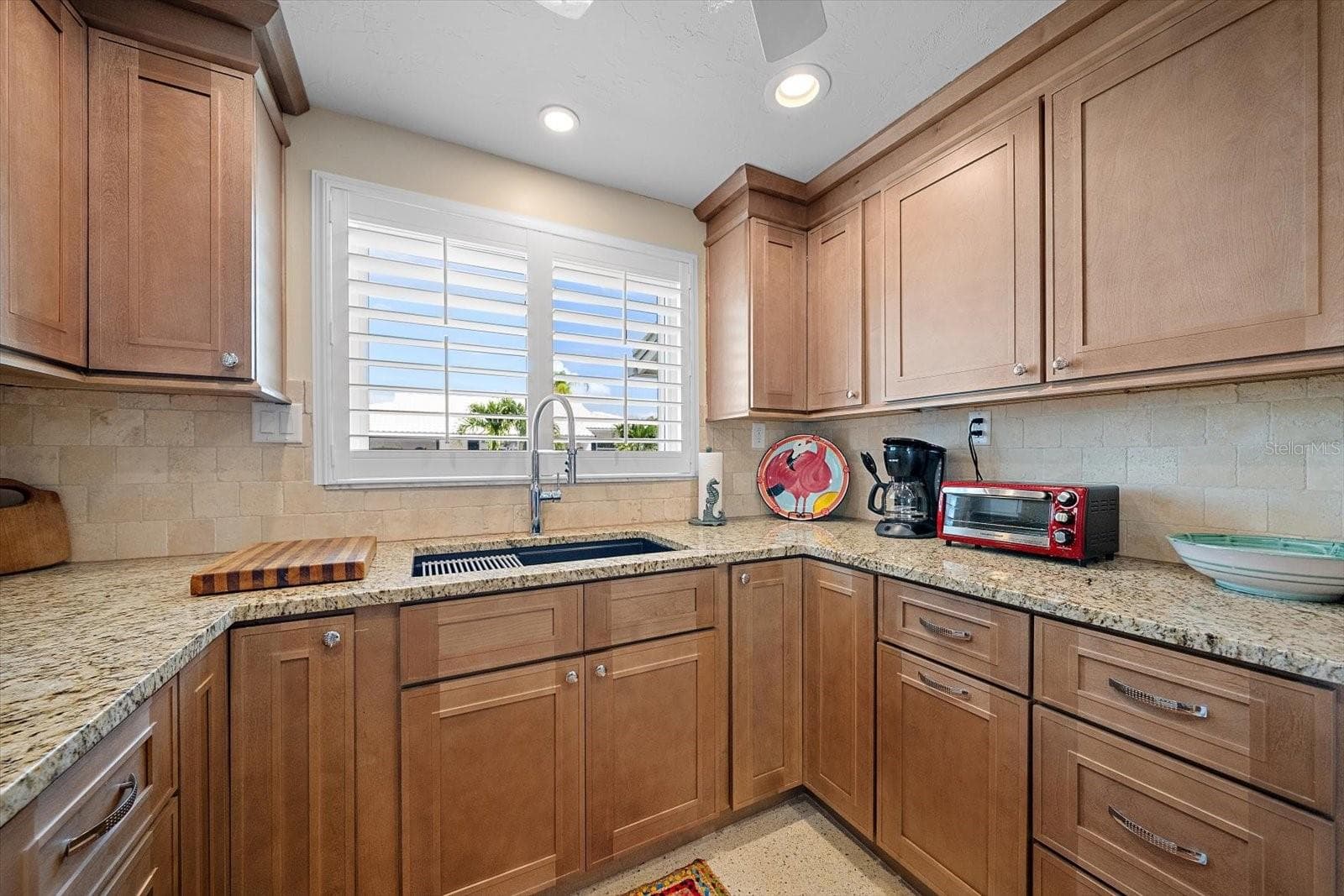 Kitchen with sink and wood cabinetry - 738 SPANISH DR S #98, LONGBOAT KEY