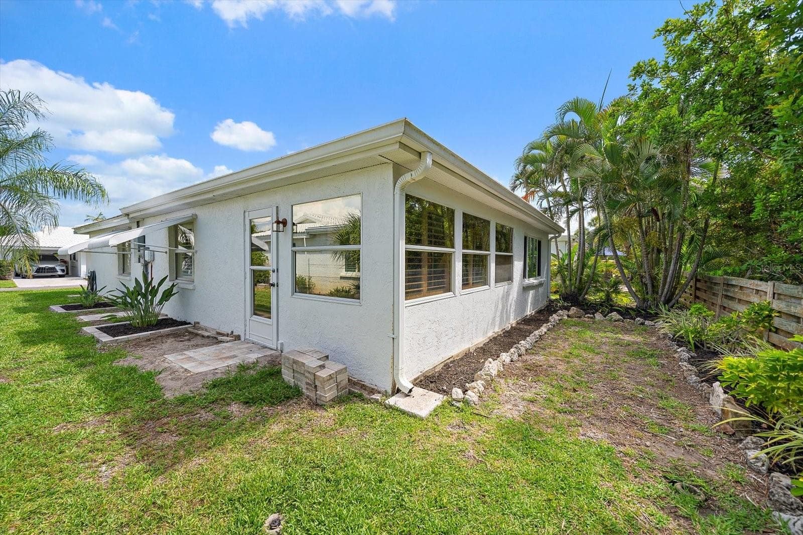 Exterior side view with carport and landscaping - 738 SPANISH DR S #98, LONGBOAT KEY