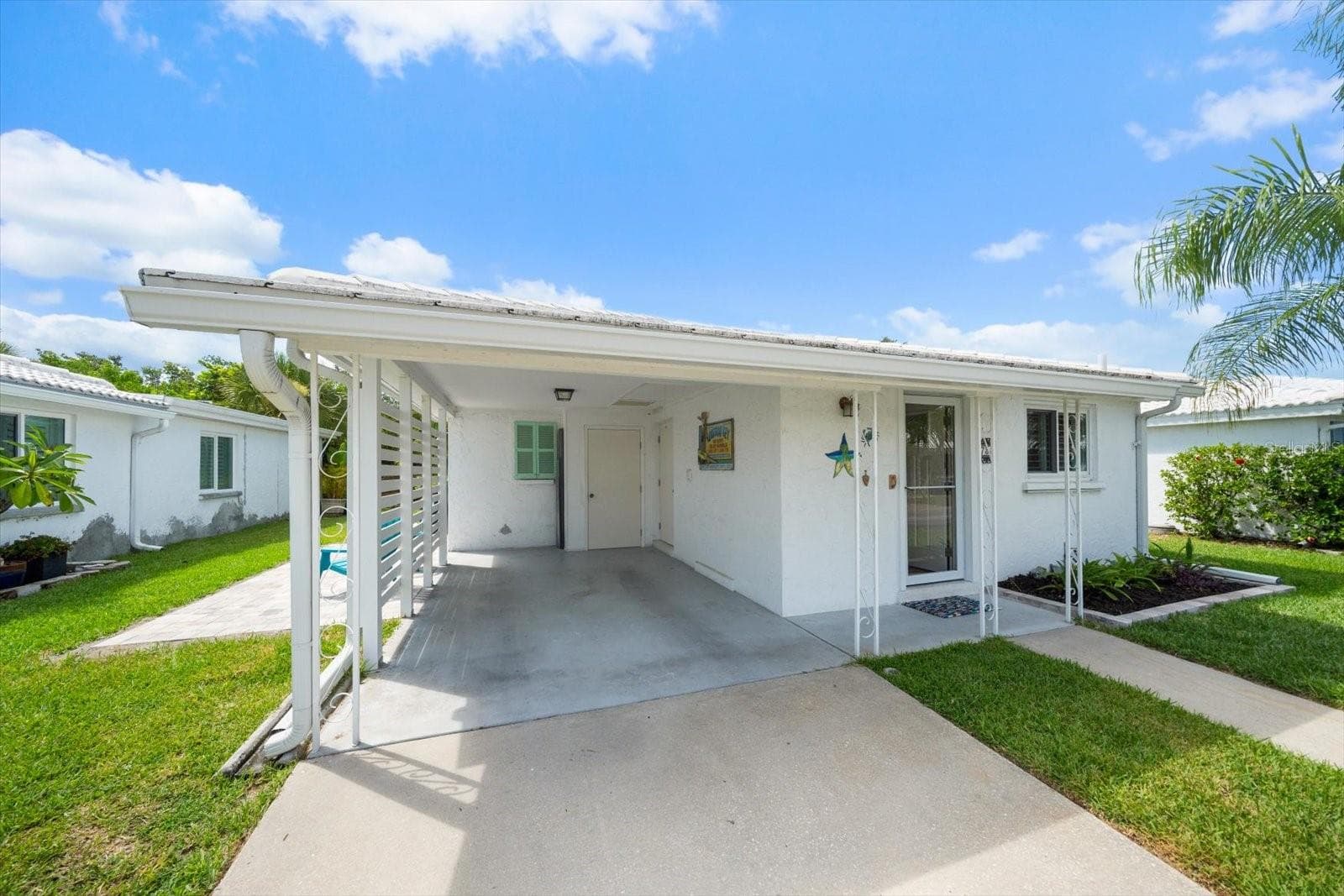 Exterior front view of unit and carport - 738 SPANISH DR S #98, LONGBOAT KEY