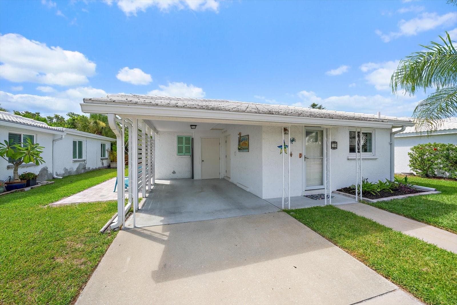 Exterior front view of unit and carport - 738 SPANISH DR S #98, LONGBOAT KEY