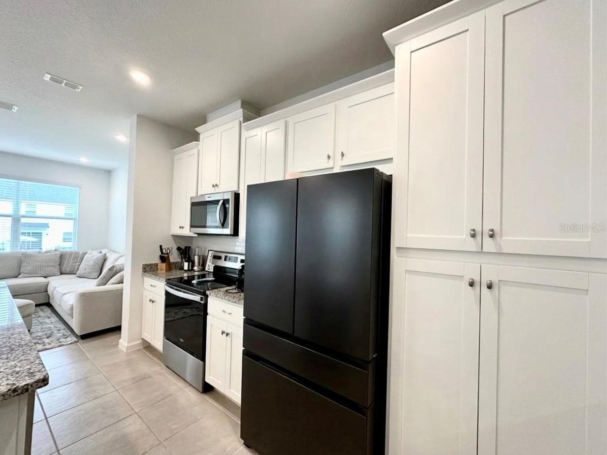 Black and stain steel appliances - 1123 BOARDWALK PL, KISSIMMEE