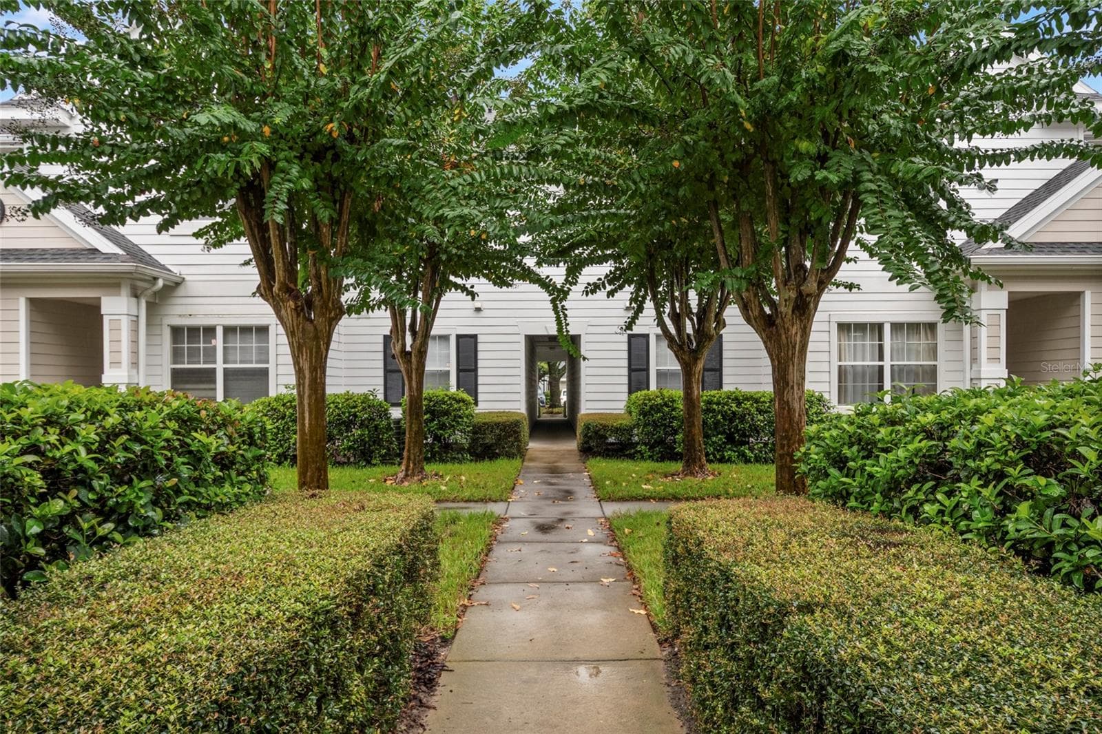Well manicured mature landscaping greets you as you approach building 14, unit 208 - 1300 EASTERN PECAN PL #208, WINTER GARDEN