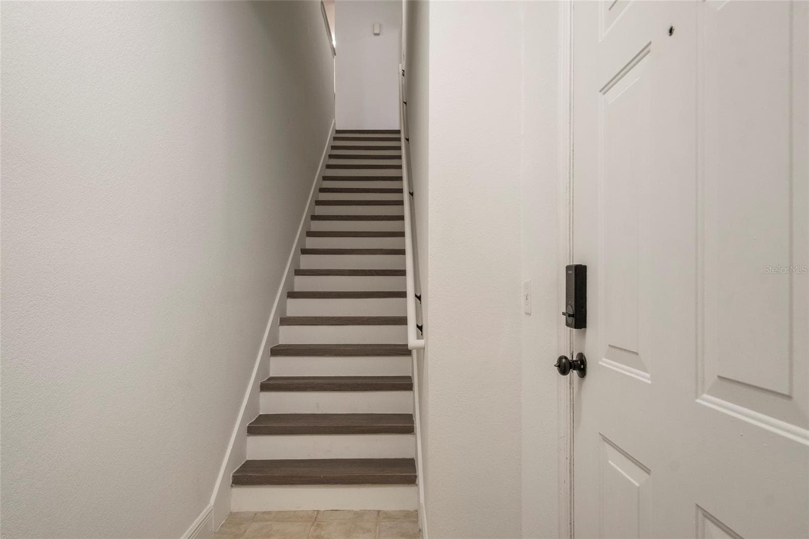 Ascend the stairs and notice the handrail, risers and all interior walls, ceiling and trim are ALL freshly painted. - 1300 EASTERN PECAN PL #208, WINTER GARDEN