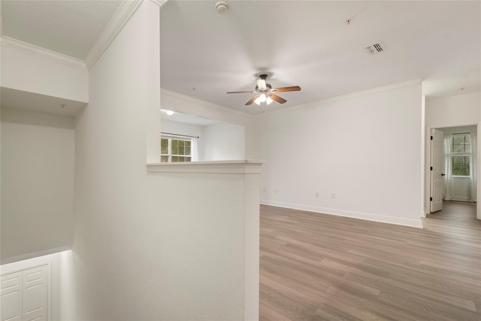 At the top of the stairs the luxury plank vinyl is revealed with a convenient capped half way to place your keys, phone and mail. - 1300 EASTERN PECAN PL #208, WINTER GARDEN