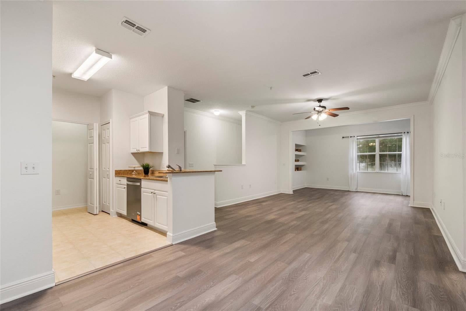 The full view of the expansive combination of Kitchen, dining, family and alcove. Generously sized at 1453 square feet the 3 bedrooms and 2 baths open floor plan is totally move in ready. - 1300 EASTERN PECAN PL #208, WINTER GARDEN