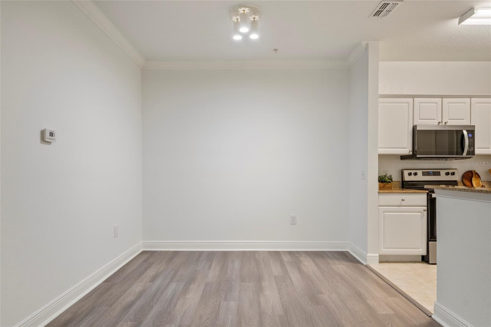 A photo of the defined dining area, ample room for a table and chairs to seat 6-10 depending on your family size. - 1300 EASTERN PECAN PL #208, WINTER GARDEN
