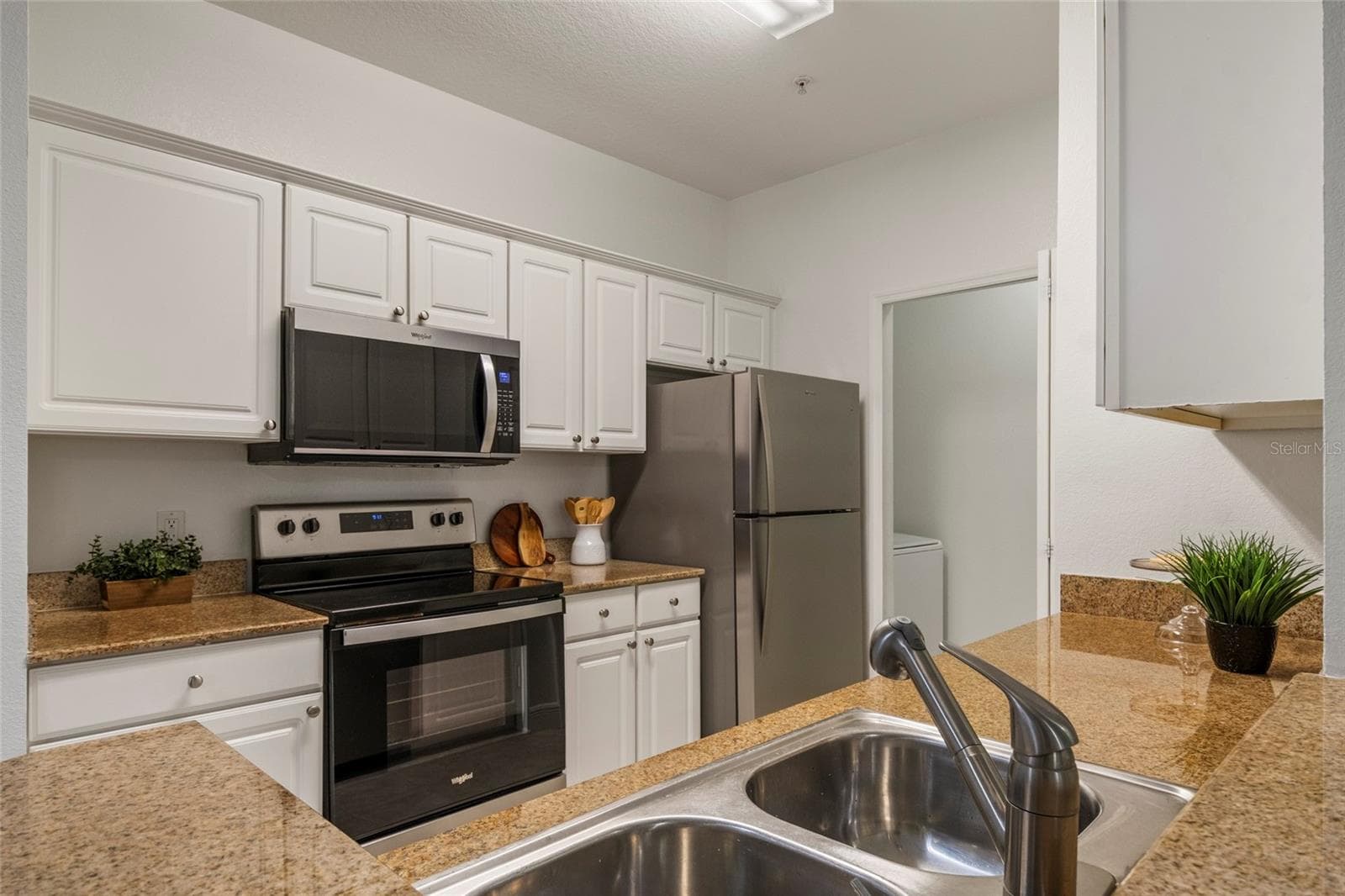 Granite countertops, brand new Microwave and Refrigerator and Dishwasher and the Range is just a few years old. - 1300 EASTERN PECAN PL #208, WINTER GARDEN