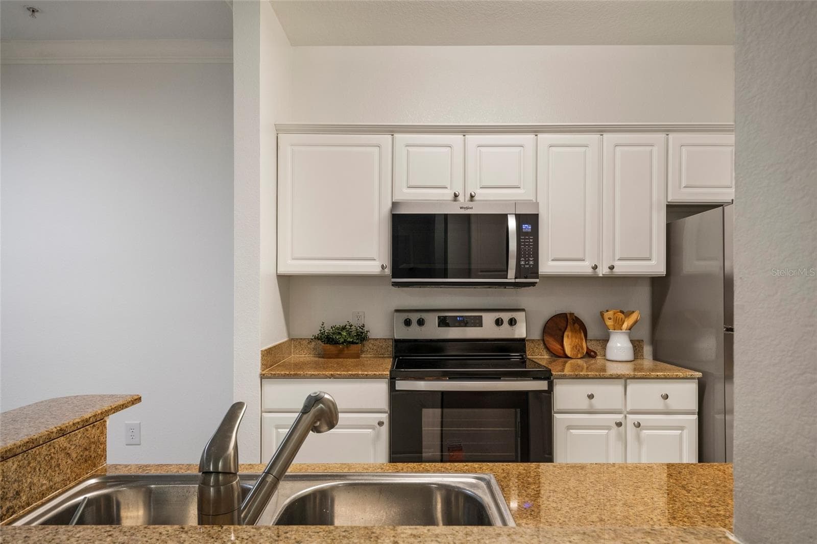 Stainless steel double sink with disposal, pull out faucet, plenty of counter space this kitchen is chef ready. - 1300 EASTERN PECAN PL #208, WINTER GARDEN