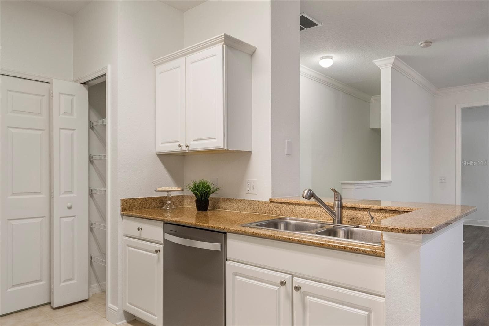 From the dining room you can see a dedicated pantry, additional counter space for prep and a two seater bar top for a quick breakfast or snack. - 1300 EASTERN PECAN PL #208, WINTER GARDEN