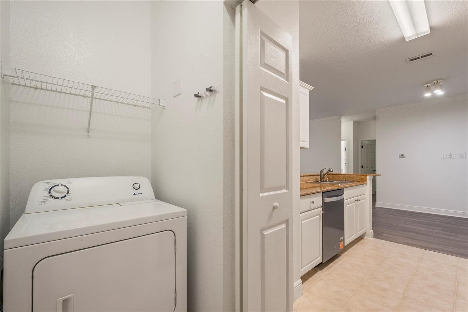 )Inside the laundry room you have a connections for washer and dryer(washer and dryer are negotiable) and have shelving over each of the appliances. - 1300 EASTERN PECAN PL #208, WINTER GARDEN