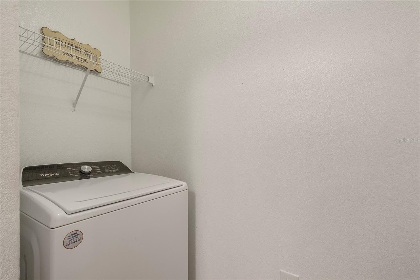 The washer sits opposite the dryer and both are negotiable with the sale of the unit also featuring storage shelving above. All walls freshly painted as if it were brand new. - 1300 EASTERN PECAN PL #208, WINTER GARDEN