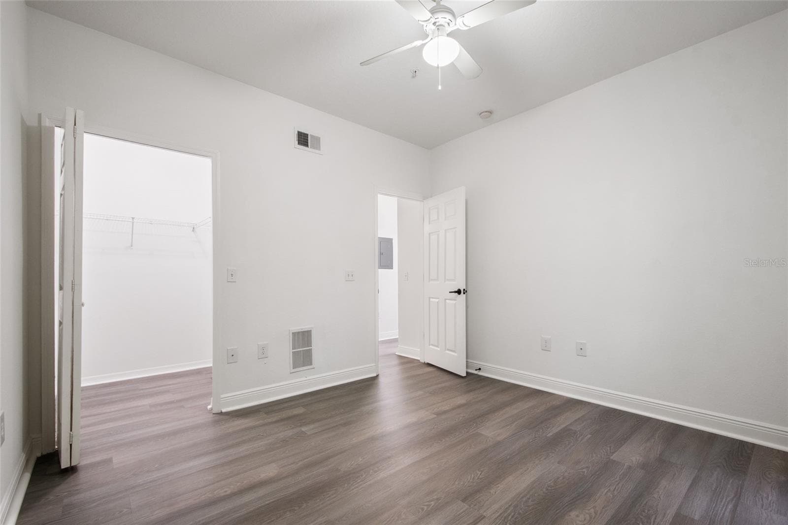Bedroom 3 features all luxury plank vinyl all the way through the walk in closet, ceiling fan, freshly painted walls, ceilings, trim and door with a new lever handle it is ready for its new owner. - 1300 EASTERN PECAN PL #208, WINTER GARDEN