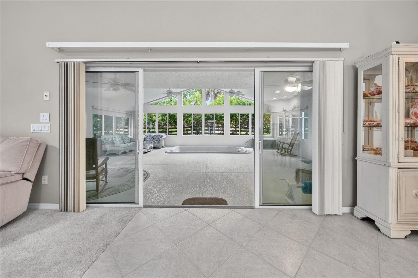 LIVING ROOM TO ENCLOSED LANAI - 9245 SE 169TH BENTLEY ST, THE VILLAGES