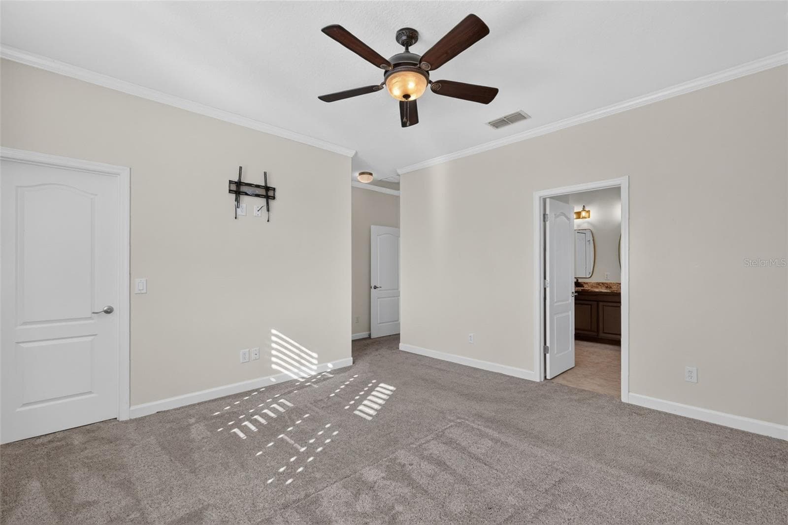 View of primary suite, walk-in closet on left, ensuite bathroom on right ~ - 4913 ROYCE DR, MOUNT DORA