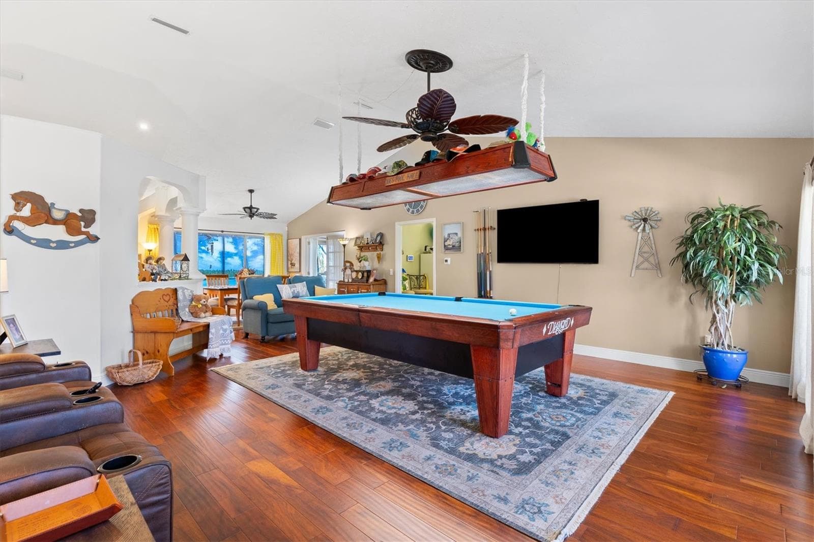 Living room with engineered hardwood floors, vaulted ceilings. Currently being utilized for a billiard room. (pool table negotiable.) - 17432 SE 112TH CT, SUMMERFIELD