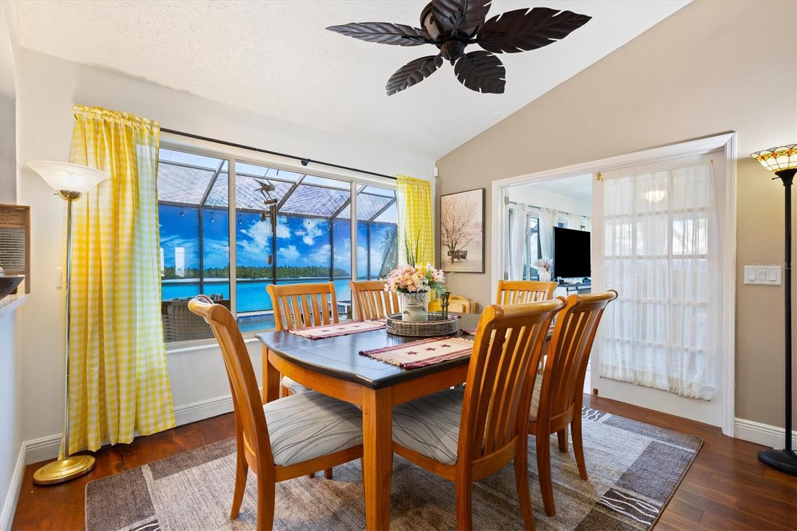 Dining room with view of outside oasis through window. Under air lanai through the French doors to the right. - 17432 SE 112TH CT, SUMMERFIELD
