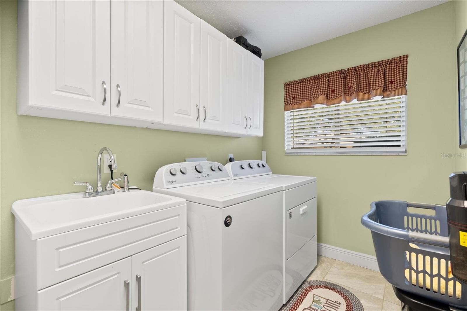 Inside laundry room with utility sink. - 17432 SE 112TH CT, SUMMERFIELD