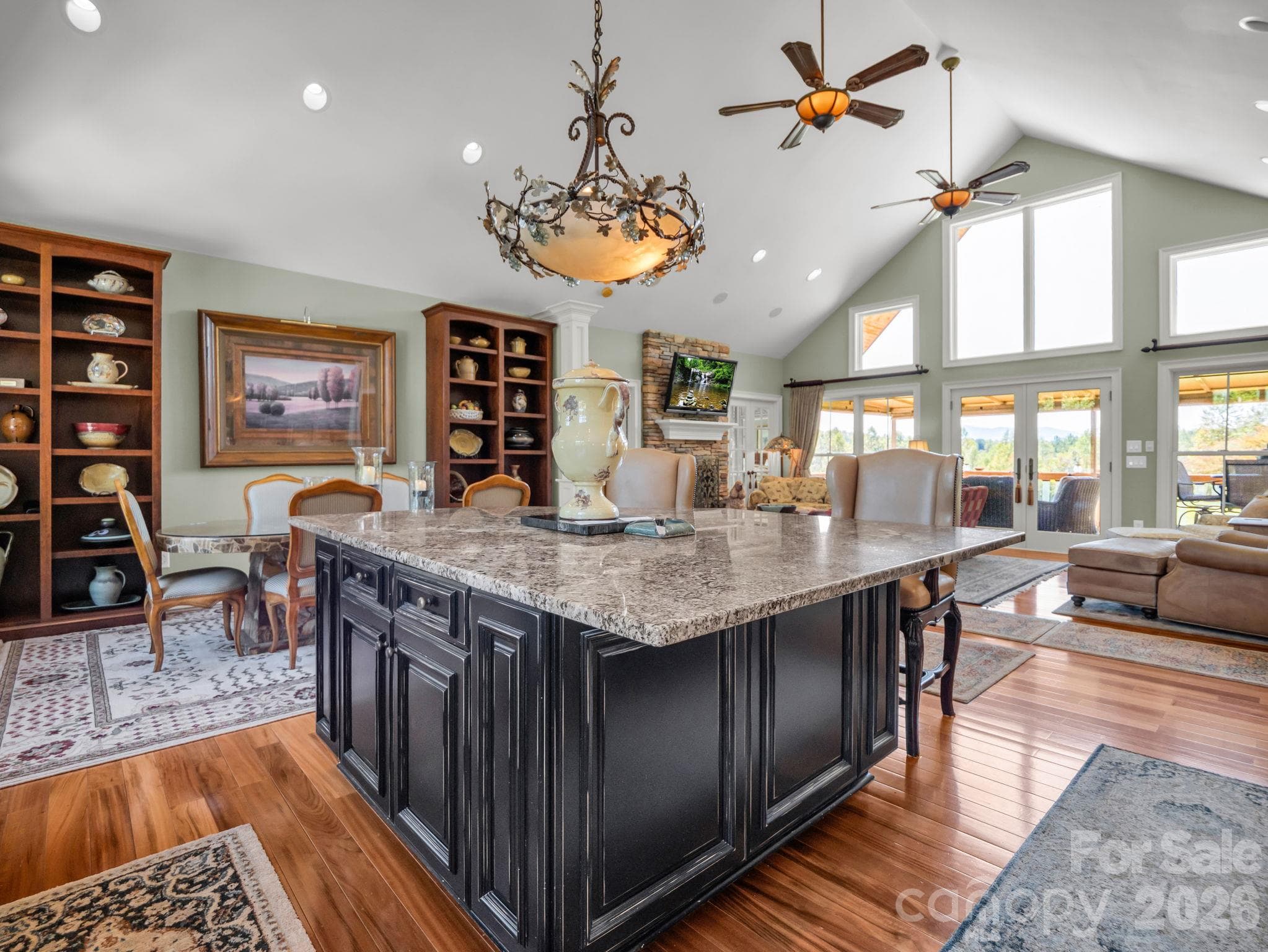 Oversized island wrapped in granite, vaulted ceilings and a see-through fire place - 140 Blazing Star Lane, Mill Spring