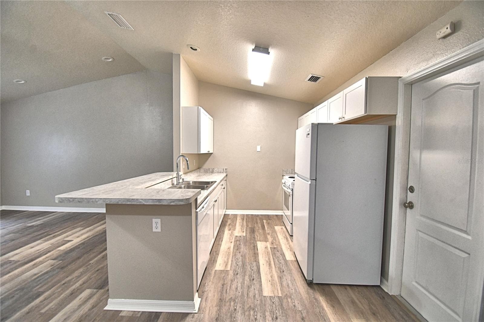 Kitchen with sitting space at bar. - 3779 RED OAK CT, LAKE WALES