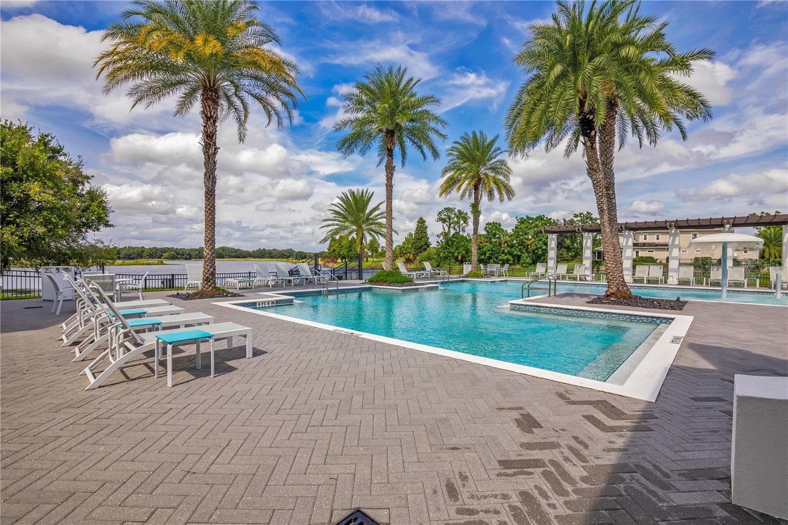 Relax and unwind at the stunning resort-style community pool surrounded by tropical landscaping. - 15749 CUTTER SAIL PL, WINTER GARDEN