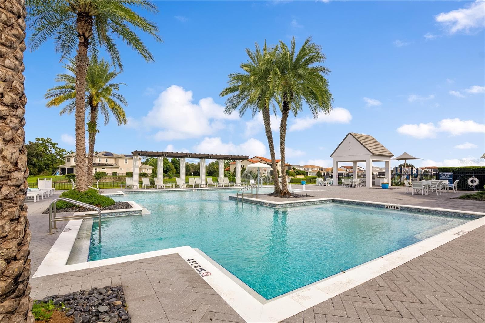 Relax and unwind at the stunning resort-style community pool surrounded by tropical landscaping. - 15749 CUTTER SAIL PL, WINTER GARDEN