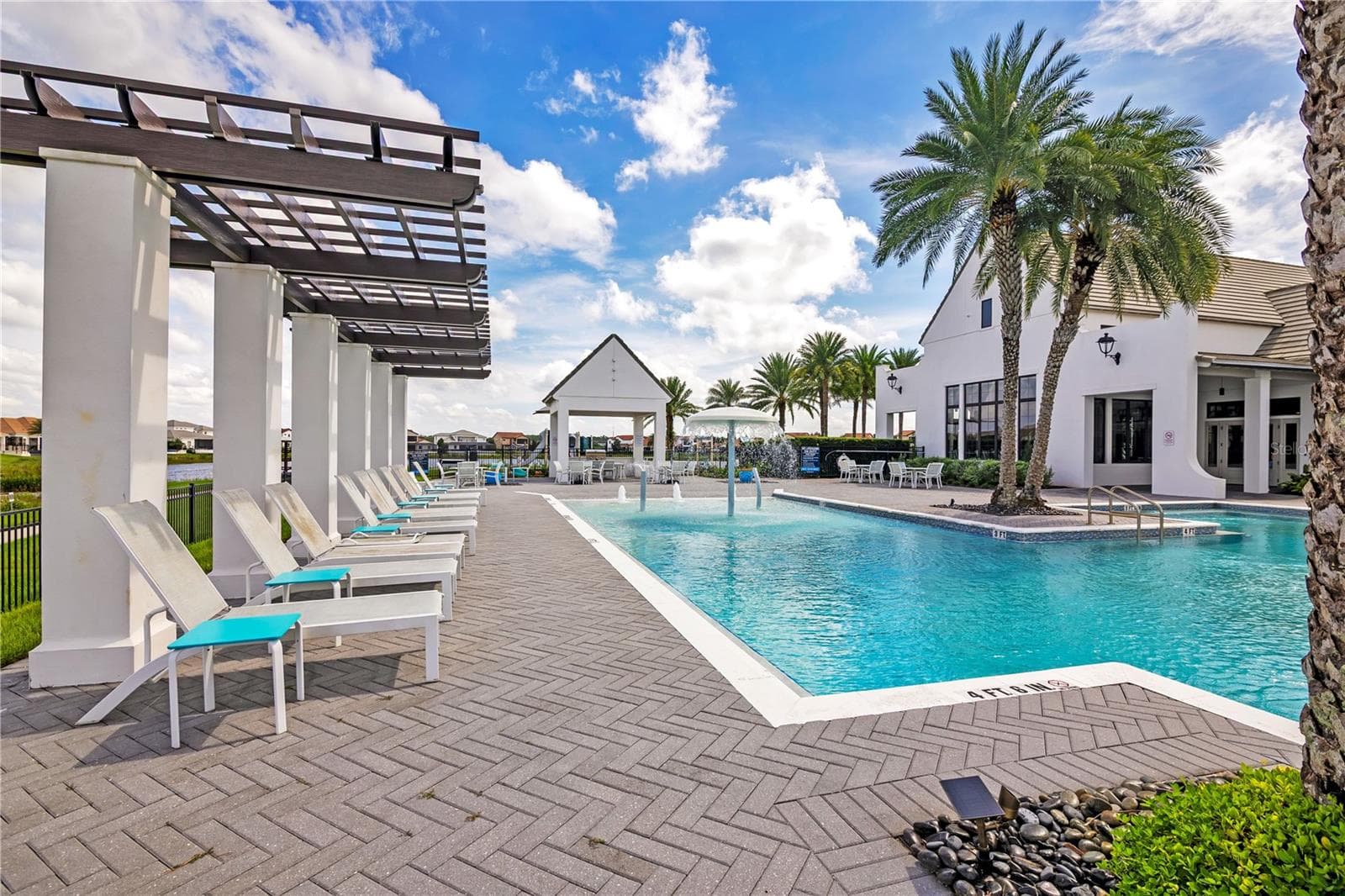 Enjoy the Florida sunshine from comfortable poolside seating and shaded relaxation areas. - 15749 CUTTER SAIL PL, WINTER GARDEN