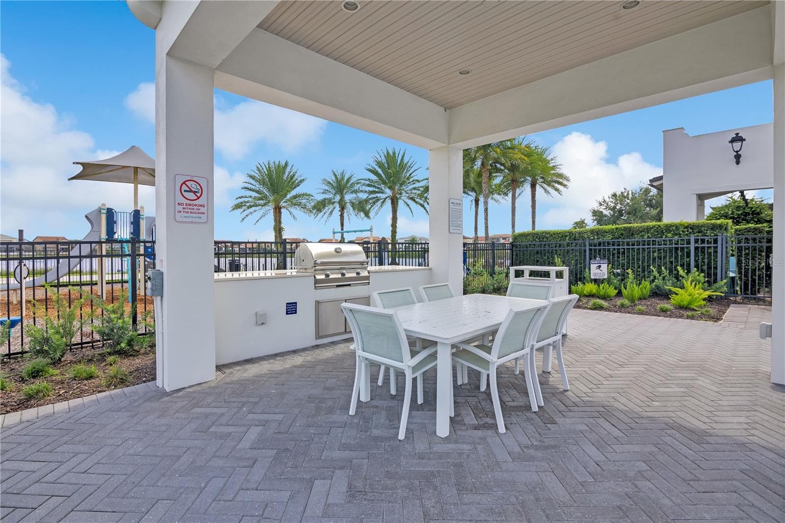 Covered community grilling and dining area, perfect for outdoor gatherings. - 15749 CUTTER SAIL PL, WINTER GARDEN