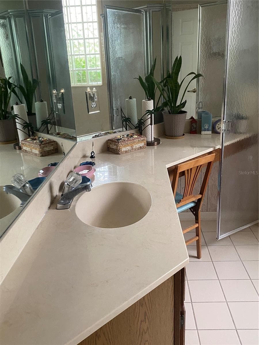 Primary bathroom with drawers and sitting area large mirror - 11492 SW 82ND COURT RD, OCALA