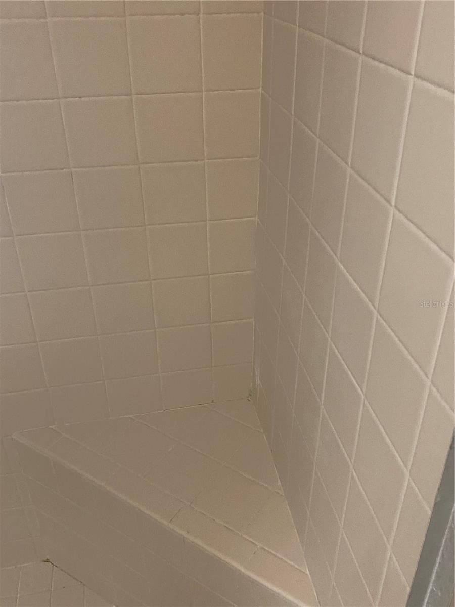 Guest bathroom showder with bench area. - 11492 SW 82ND COURT RD, OCALA