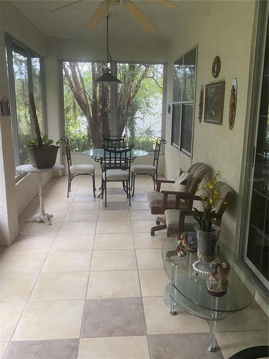 Screened in lanai facing the backyard with tiles flooring - 11492 SW 82ND COURT RD, OCALA