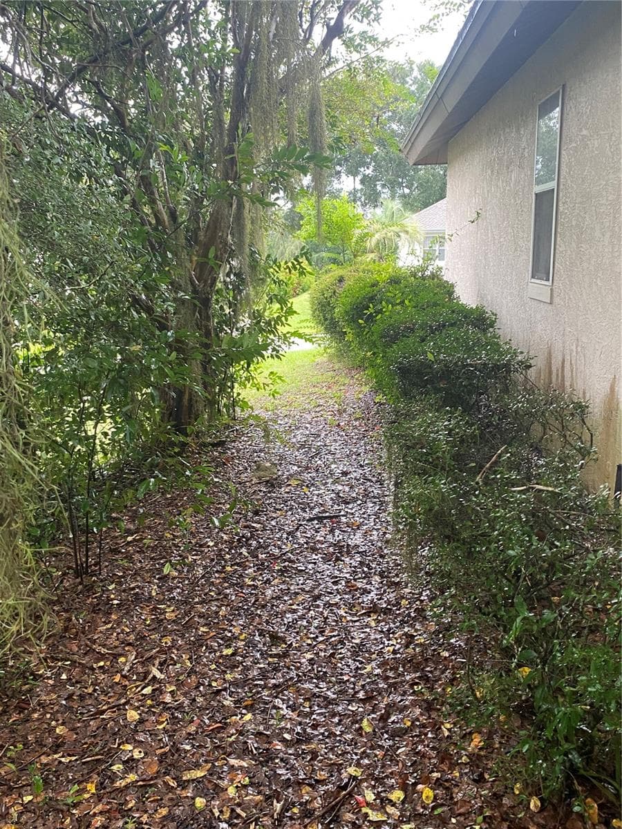 Side of the house walkway. - 11492 SW 82ND COURT RD, OCALA