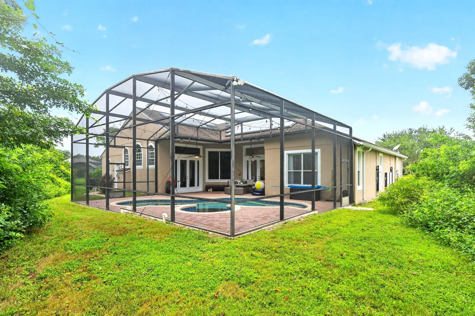 Mature trees add privacy to the screened pool. - 609 VIANA CT, WINTER SPRINGS