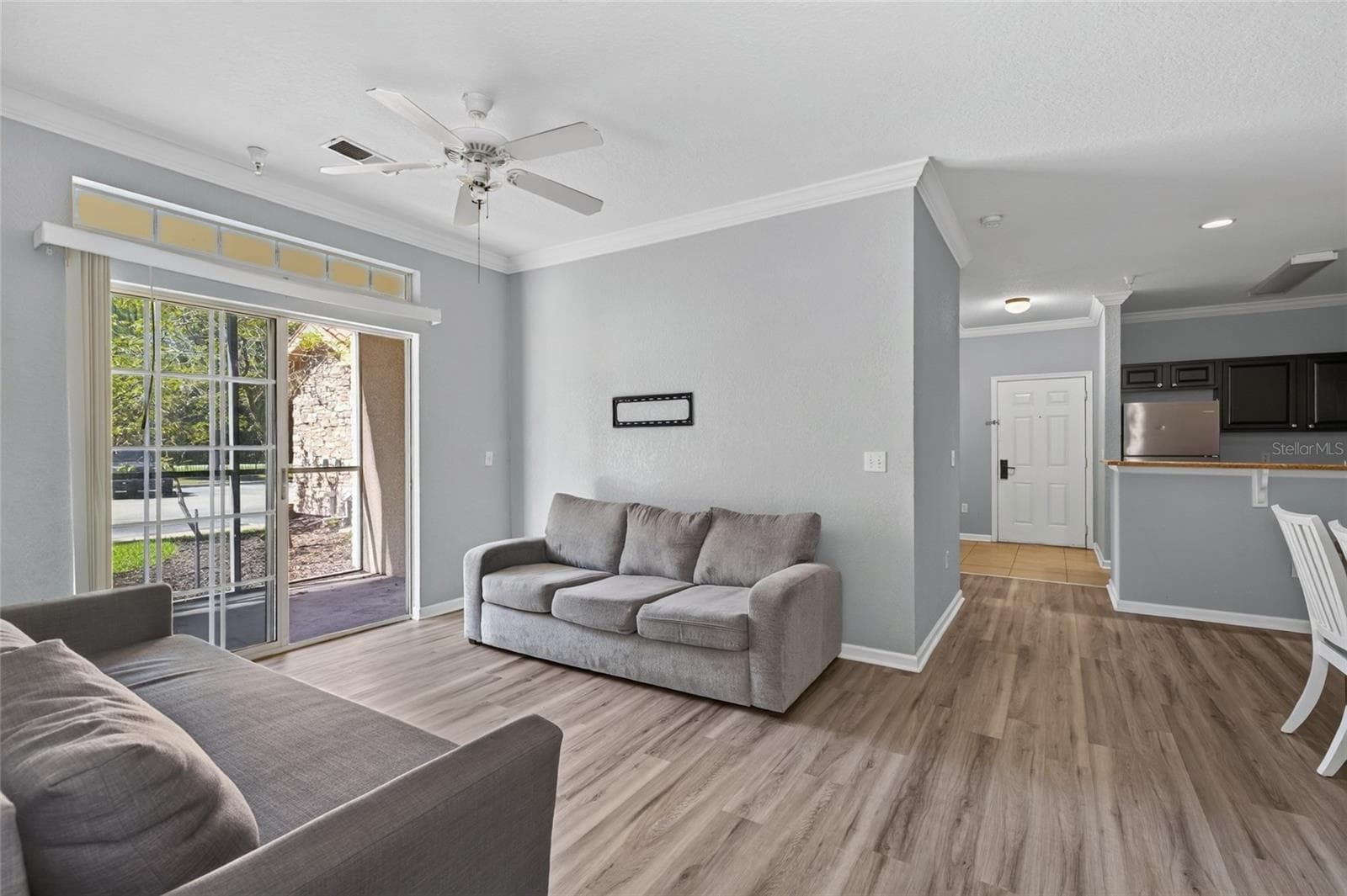 LIVING ROOM & SCREENED PATIO, Southwest facing. Front entry and kitchen directly ahead. - 1351 TUSCAN TER #8104, DAVENPORT