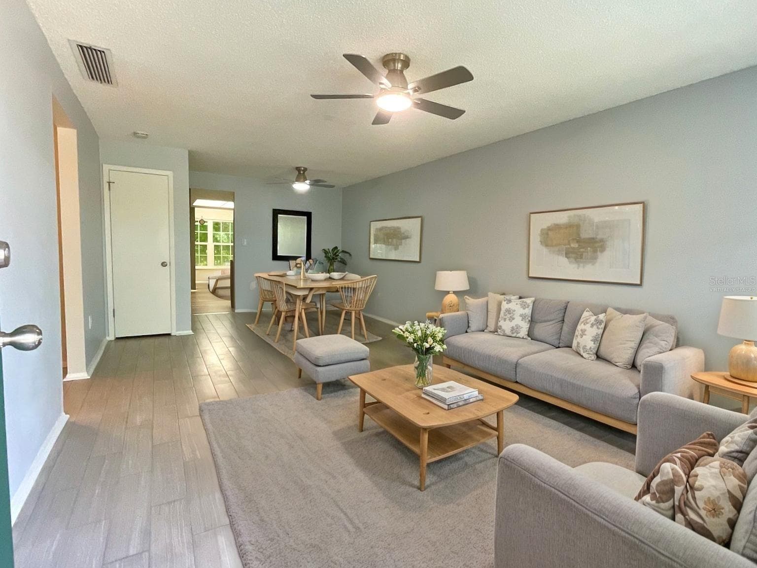 Virtually staged-living room and dining area. - 1020 85TH AVE N #222, ST PETERSBURG