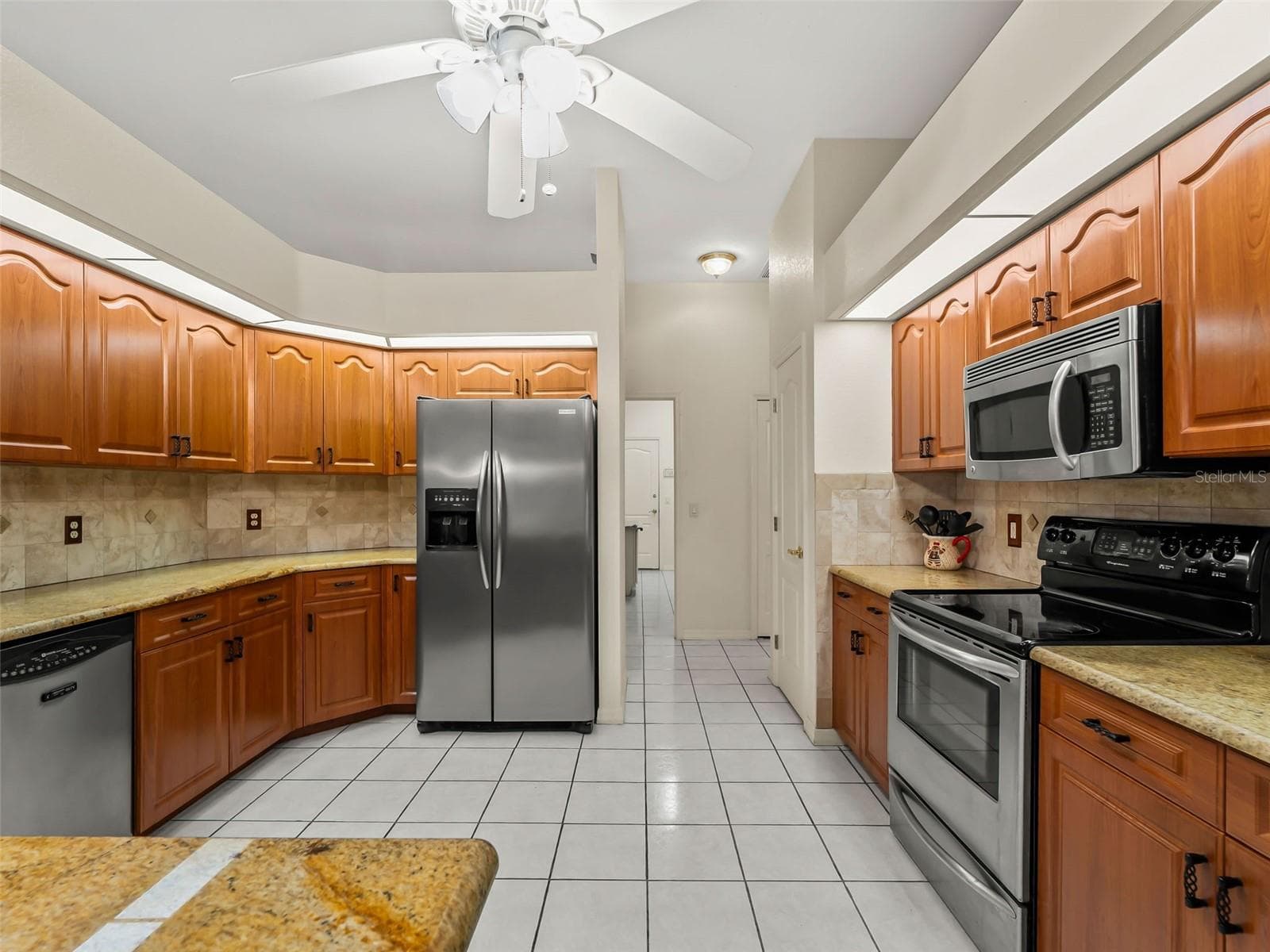 Kitchen_9336StPaulDr_PortCharlotte_WoodCabinetry_Corner.jpg - 9336 ST PAUL DR, PORT CHARLOTTE