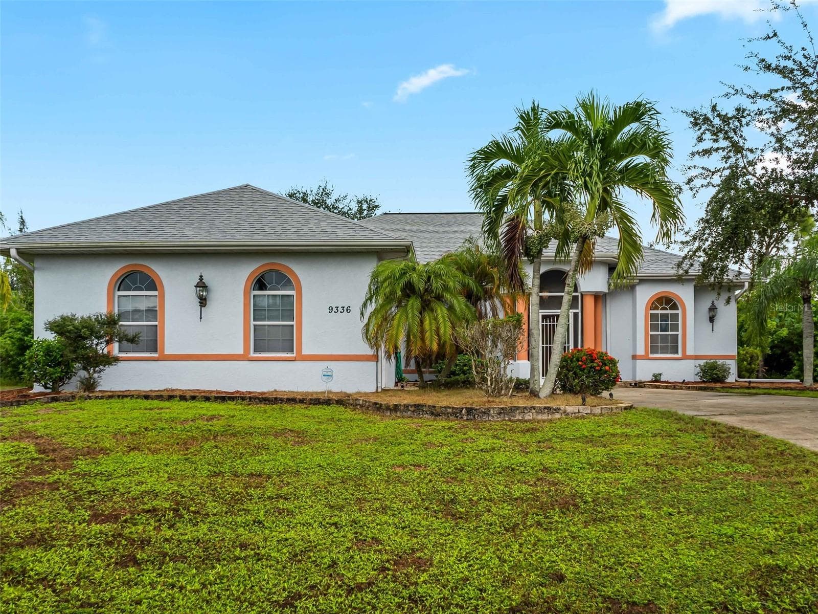 FrontExterior_9336StPaulDr_PortCharlotte_TropicalLandscaping_Daylight.jpg - 9336 ST PAUL DR, PORT CHARLOTTE