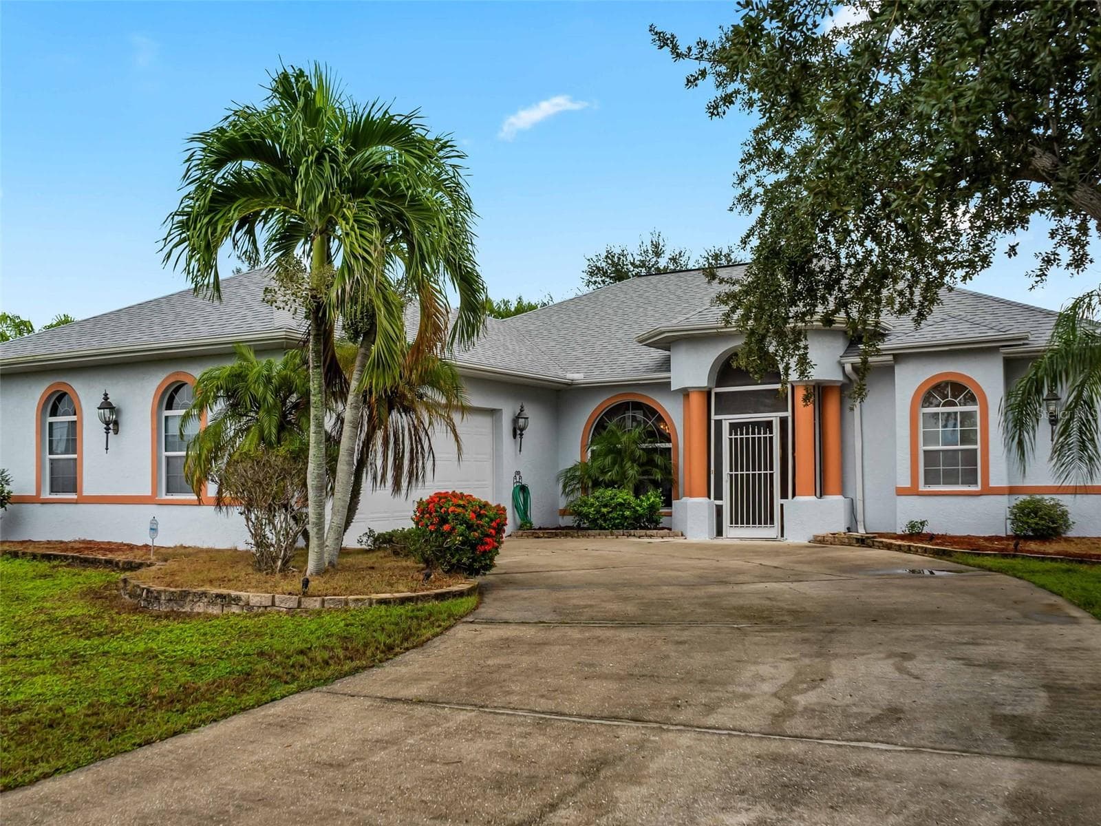 FrontExterior_9336StPaulDr_PortCharlotte_TropicalLandscaping_Corner.jpg - 9336 ST PAUL DR, PORT CHARLOTTE