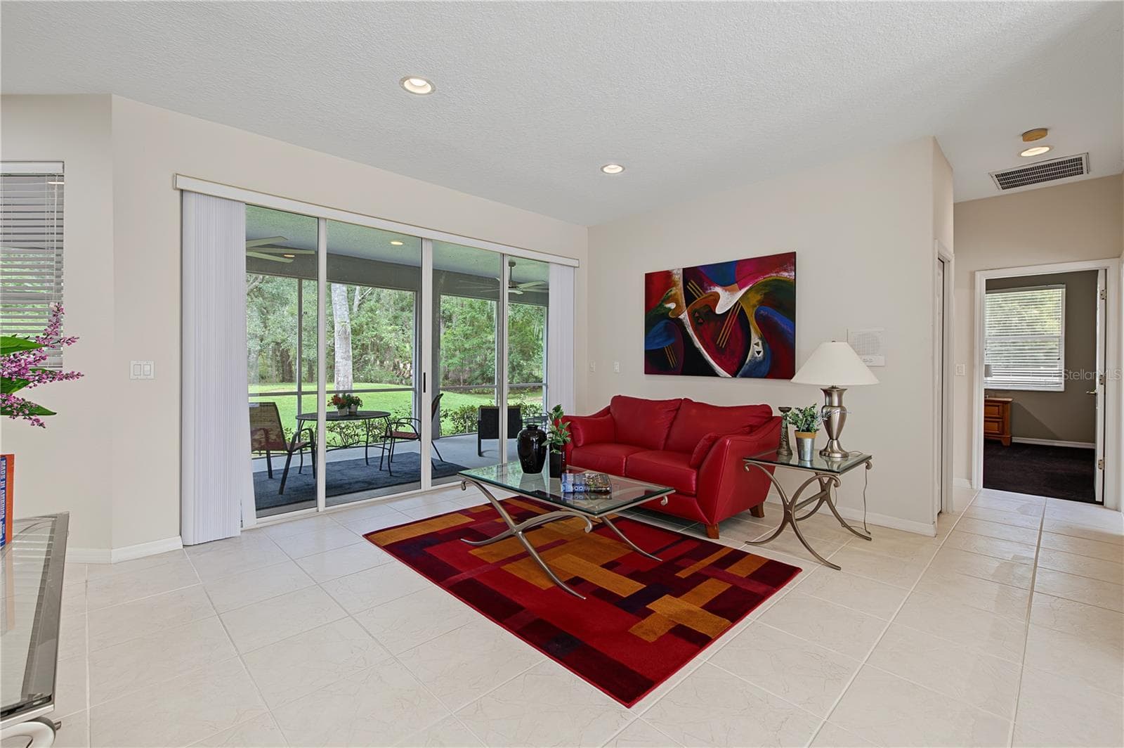 Living Room overlooking the backyard and patio - 915 LAKE THOMAS LN, LUTZ