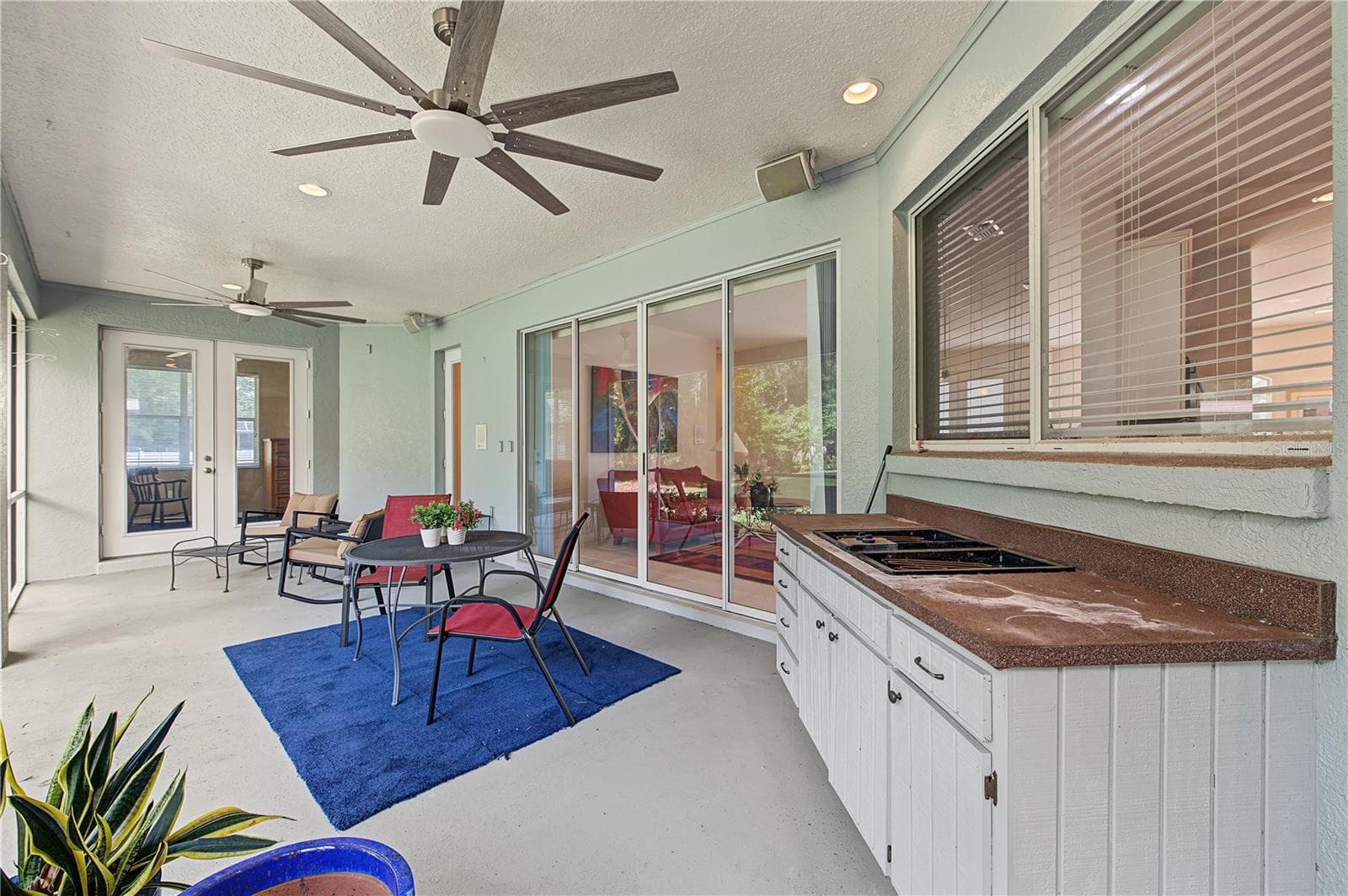 Back Porch with new ceiling fans - French doors off of the master Bedroom - 915 LAKE THOMAS LN, LUTZ