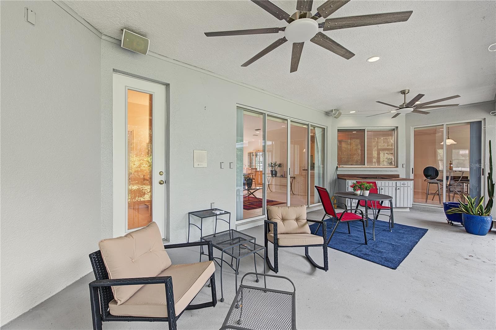 Back Porch with new ceiling fans - French doors off of the master Bedroom - 915 LAKE THOMAS LN, LUTZ