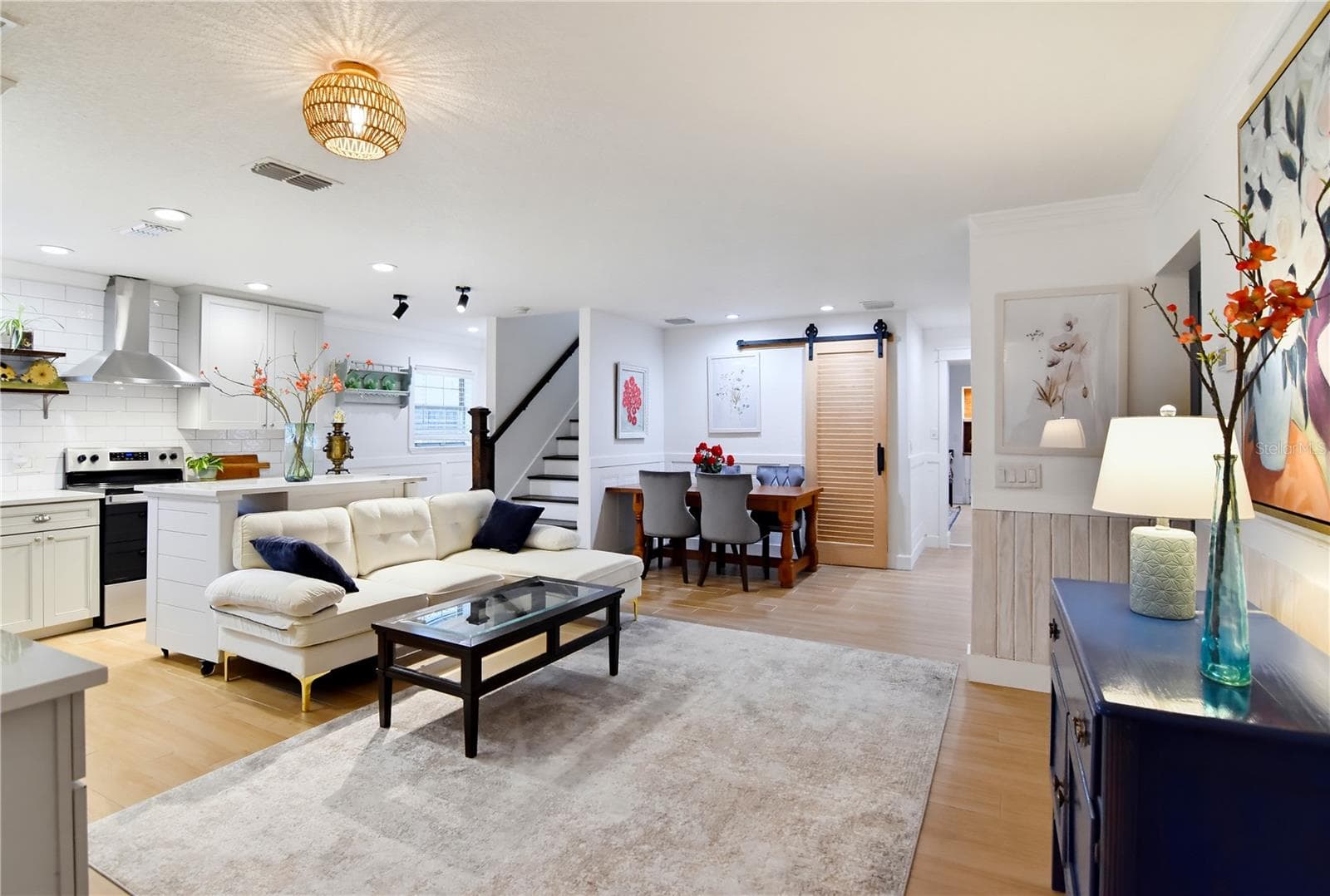 Bright, open-concept living and dining spaces with a beautifully redesigned kitchen. - 1611 CHESTNUT AVE, WINTER PARK