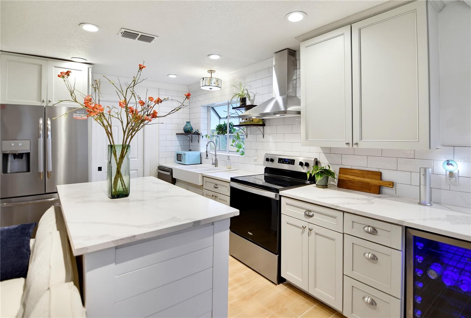 Generous kitchen workspace with custom cabinetry, modern finishes, and a functional island. - 1611 CHESTNUT AVE, WINTER PARK