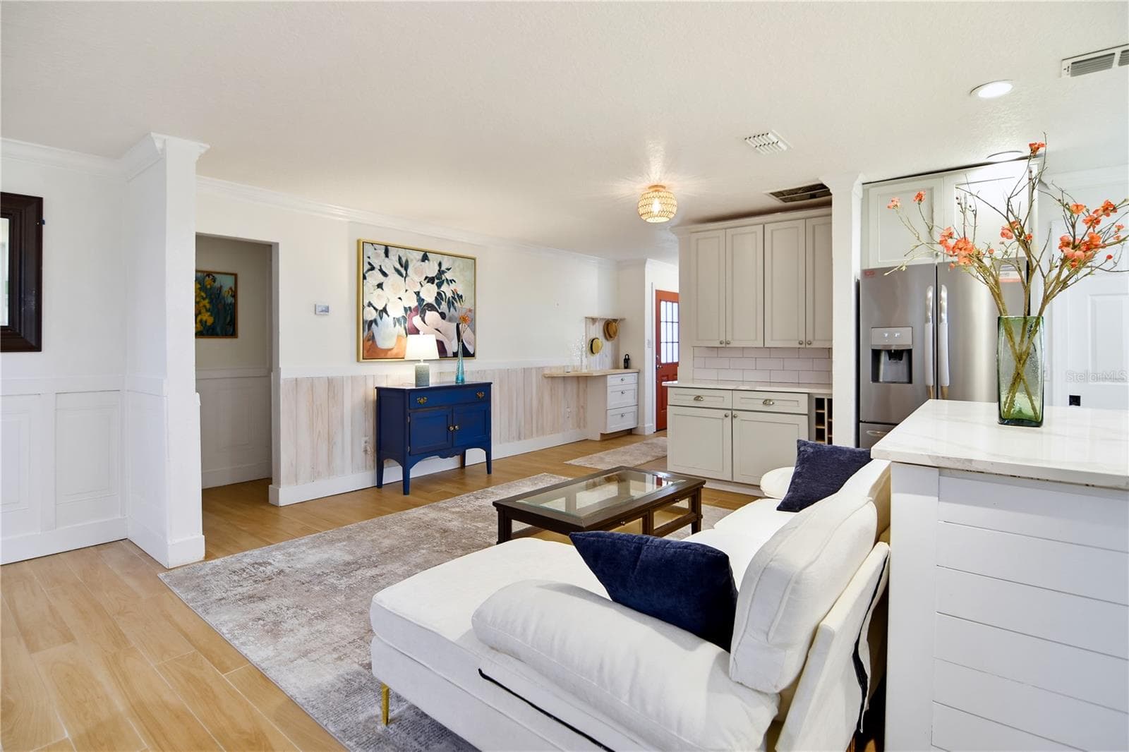 Expansive family room featuring a stone fireplace, built-in cabinetry, and generous seating space. - 1611 CHESTNUT AVE, WINTER PARK