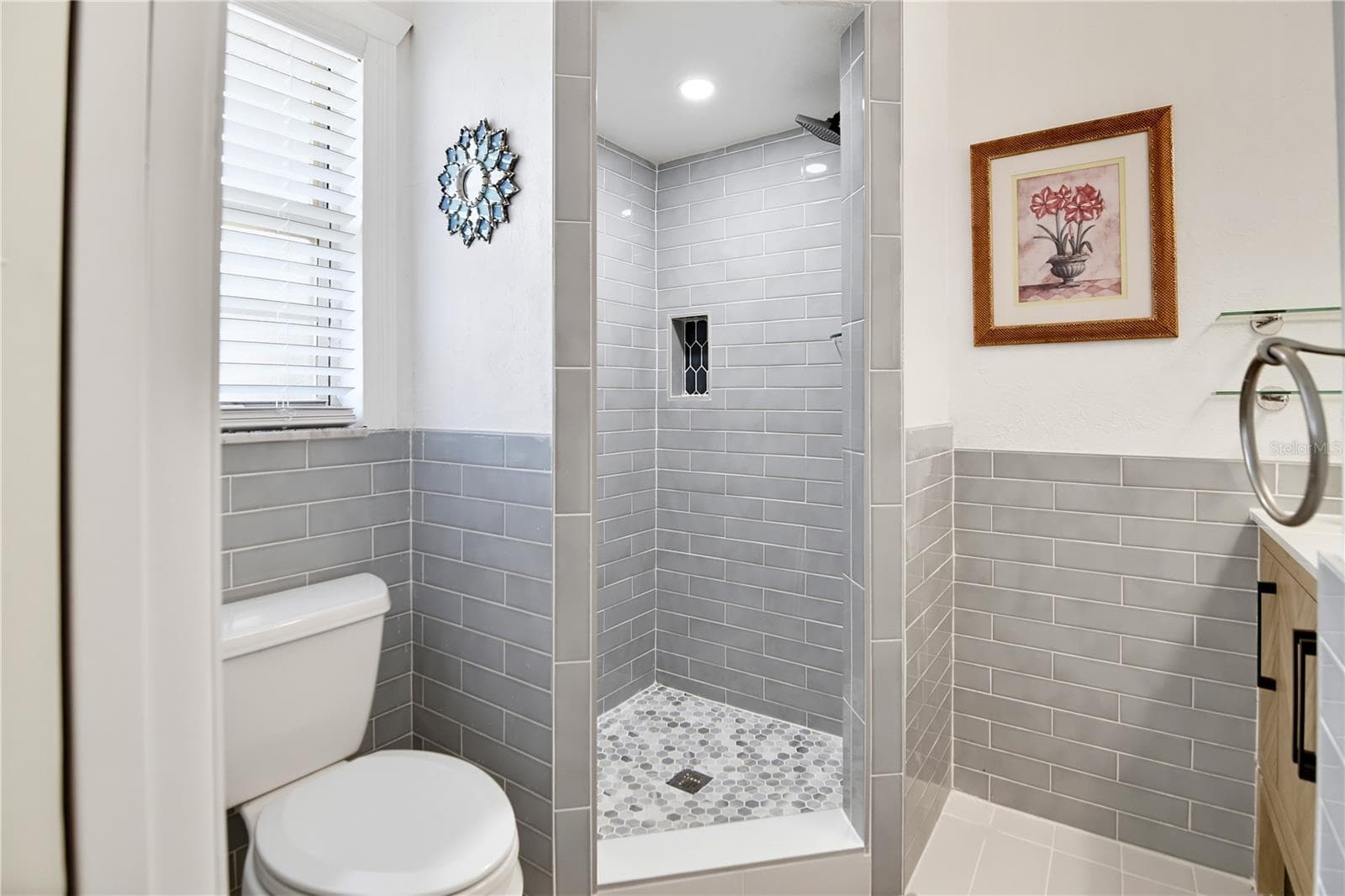Tastefully updated bathroom with tiled walk-in shower and contemporary finishes. - 1611 CHESTNUT AVE, WINTER PARK